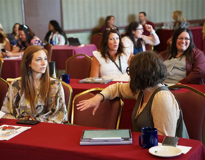 Attendees discuss at the AIU's SEL day.